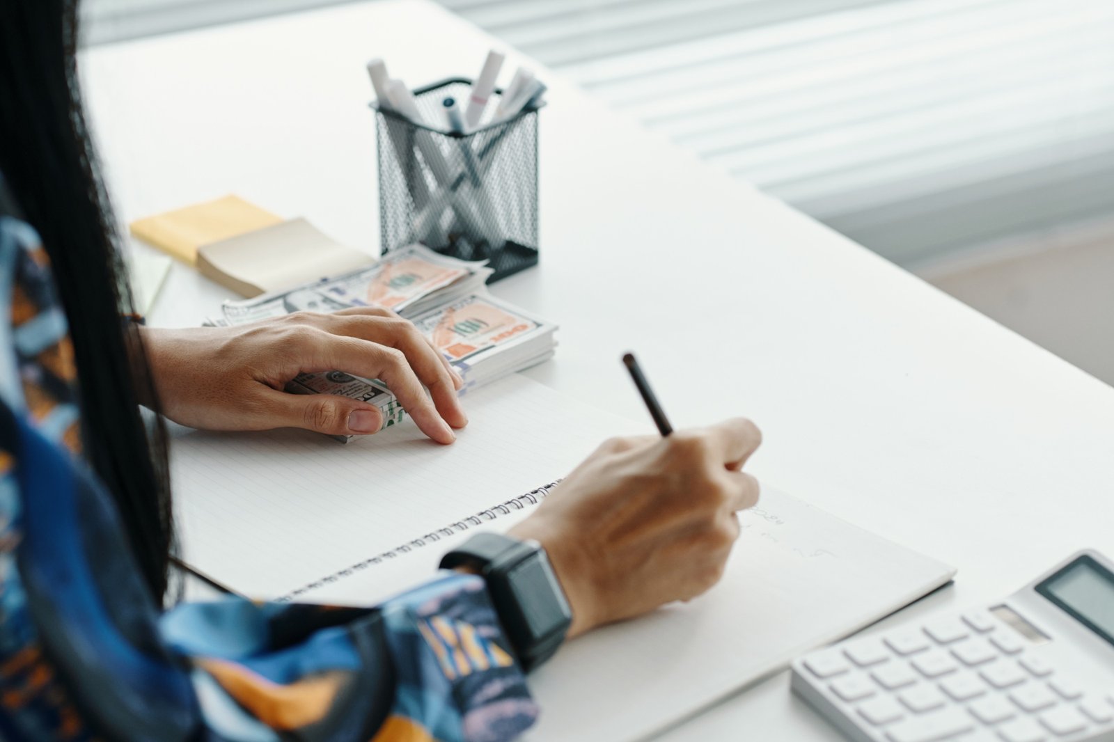 Unrecognizable Bank Worker Making Notes